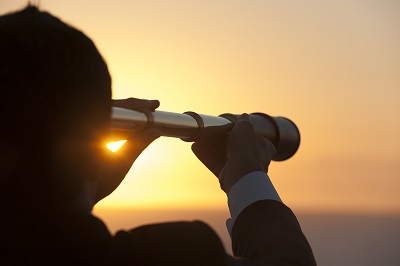 a man standing in front of a sunset